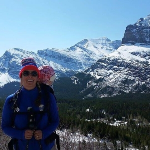 Carrying a baby to Iceberg Lake is one of the best hikes for kids in Glacier National Park.