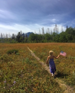 A happy five year old on one of the best hikes for kids in Glacier National Park, the Beaver Lakes Loop.