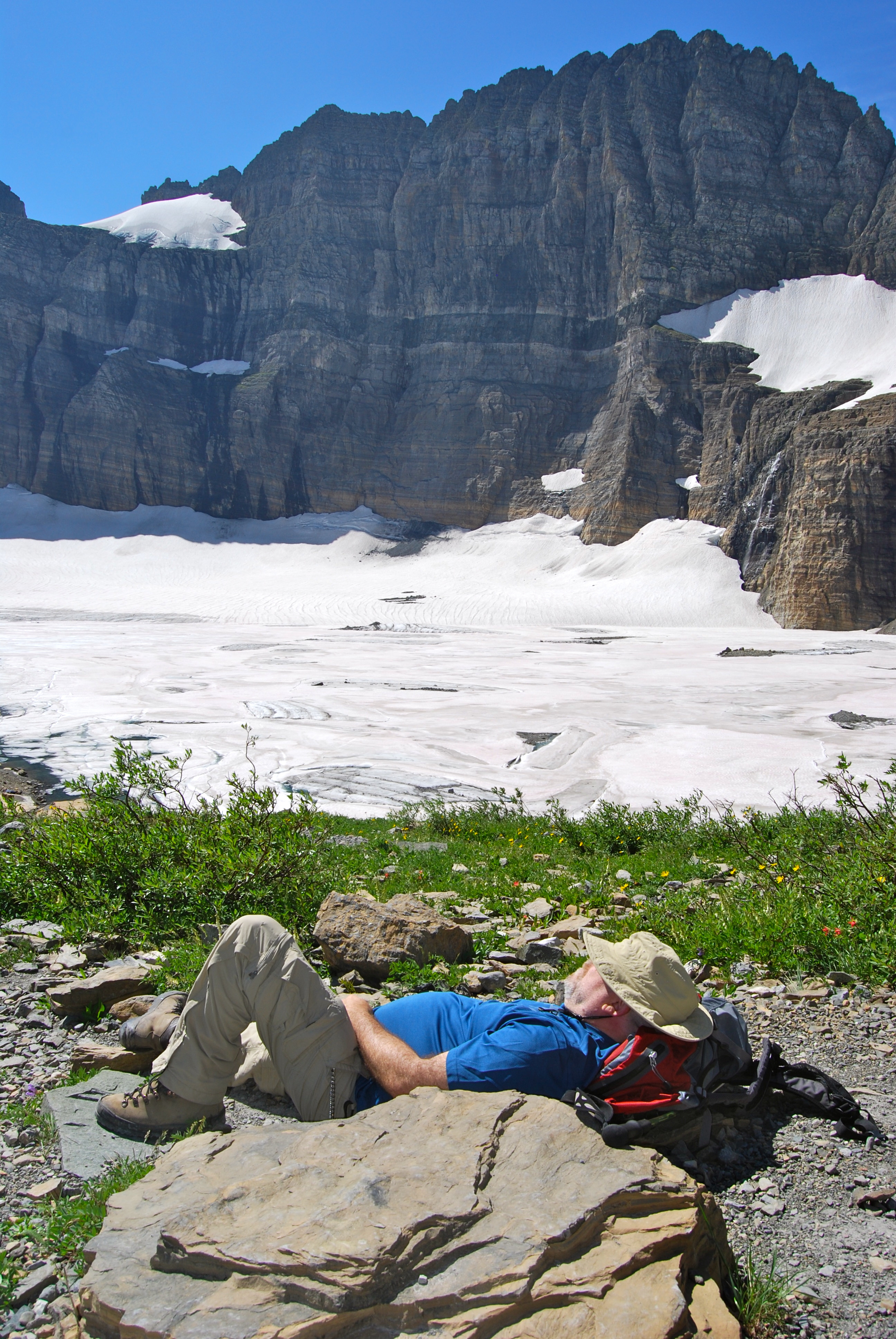 We are thankful for Glacier National Park and a Glacier Guides guest napping below Grinnell Glacier in Glacier National Park, Montana.