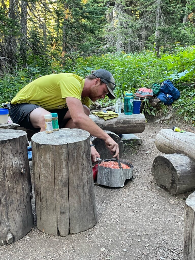 Guide Todd Bauer cooking on a backpacking trip. 10 reasons to explore glacier with a guide
