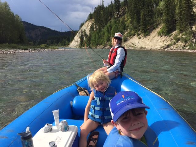 A happy Glacier National Park family whitewater rafting Paola Creek to Cascadilla on the Middle Fork of the Flathead River, Montana.